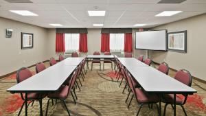 a conference room with tables and chairs and a whiteboard at Best Western Dayton Inn & Suites in Dayton +20 photos