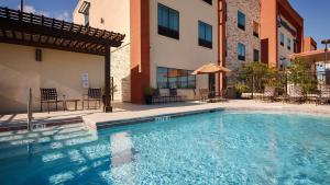 a swimming pool in front of a building at Best Western Plus College Station Inn & Suites in College Station
