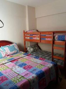 a bedroom with a bed and a dresser in it at Apartamento Murimar XIII in Vila Muriqui