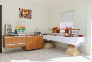 a kitchen with a counter and a counter top at Hotel São Miguel in Sorriso