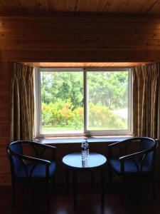 a table and chairs in front of a window at Yuli Sun Homestay in Yuli