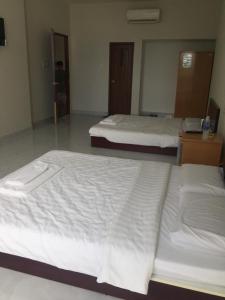 Postel nebo postele na pokoji v ubytování Phong Lan Guesthouse