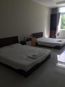 Postel nebo postele na pokoji v ubytování Phong Lan Guesthouse