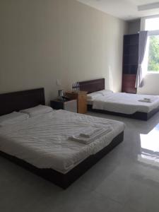 Postel nebo postele na pokoji v ubytování Phong Lan Guesthouse