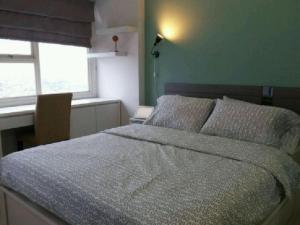 a bedroom with a large bed and a window at DSV Margonda Residen 2 Apartment in Depok