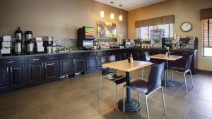 un ristorante con due tavoli e sedie in cucina di Best Western Plus Night Watchman Inn & Suites a Greensburg