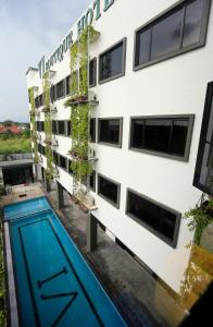 a building with a swimming pool in front of it at Vi Boutique Hotel in Kuala Selangor