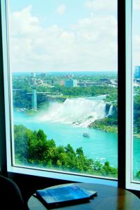 a view of niagara falls from a window at The Oakes Hotel Overlooking the Falls in Niagara Falls