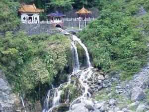 a river with a waterfall and mountains at Bear Forest Villa in Fengping
