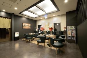 a dining room with tables and chairs and a skylight at Hotel Route-Inn Yanagawa Ekimae in Yanagawa