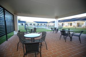 a group of tables and chairs on a patio at Roma Explorers Inn in Roma +37 photos