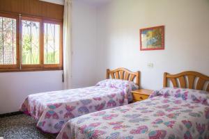 Llit o llits en una habitació de Bungalows Pascual