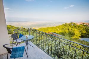 a balcony with a table and chairs and a view at Boutique Hotel BelleVue in Sighnaghi