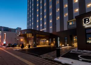 an empty street in front of a tall building at Hotel Route Inn Grand Kitami Ekimae in Kitami