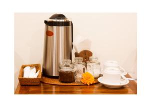 a counter with a coffee pot and jars on it at Oes House in Ubud
