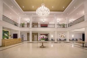a large lobby with a chandelier and a table at Grand Palace Hotel Sanur - Bali in Sanur