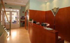 a lobby with a reception desk in a building at Hotel Ramos in Silleda