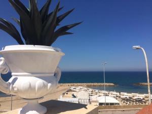 a toilet in front of a view of the ocean at Dimore di Mare in San Pietro Vernotico
