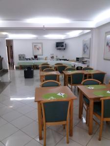 a classroom with tables and chairs in a room at Hotel Ulveira in Oliveira de Frades