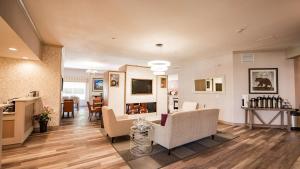 a living room with couches and a dining room at Best Western Mountainview Inn in Golden