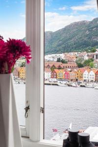 a window with a view of a body of water at Apartment with Beautiful View to Bryggen in Bergen