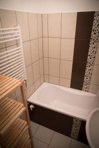 a bath tub in a bathroom with a shower at Anna Apartman in Győr