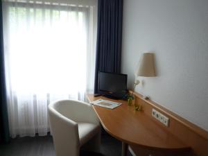 Televiisor ja/või meelelahutuskeskus majutusasutuses Mirage City Hotel Stuttgart Zentrum