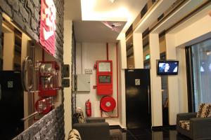 a room with two chairs and a tv in a building at Dream Hotel in Klang