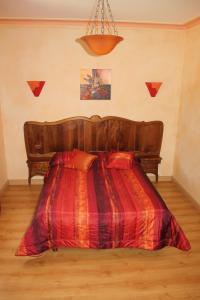 una camera con un letto con una coperta rossa di La Demeure de Bayard a Montagne