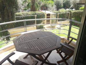 a picnic table and two chairs on a balcony at Luxury appartement 105m2-hivernage-Sofitel in Marrakesh