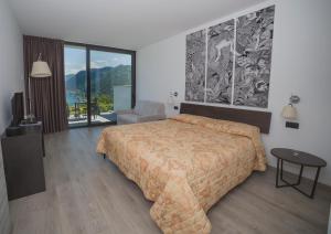 a bedroom with a large bed and a large window at B&B Vista Lago in Como