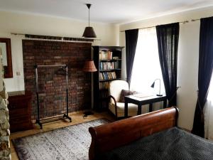 a living room with a couch and a chair and a window at Pensjonat Pod Orzechami in Magdalenka