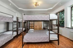 a room with four bunk beds in it at Dostyk Hostel in Almaty