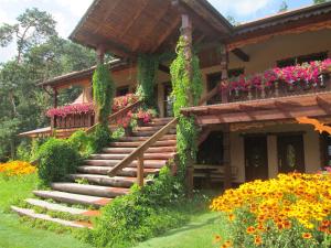 a house with stairs and flowers in front of it at Sosenka in Zalas