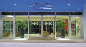 a store front with glass doors and palm trees inside at Hotel Kristal 3 Stelle Superior in Zanè