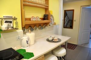 a kitchen with a counter with a table and a counter top at Angel Apartment in Krynica Zdrój