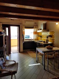 a kitchen with a table and chairs and a table and a tableablish at La Casa di Chris in Golfo Aranci