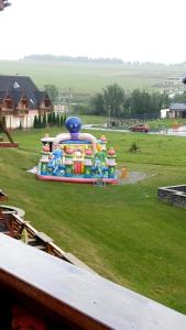 a playground with a colorful inflatablericularricularricularricularricularstrationstration at Apartmán Fiona in Veľká Lomnica