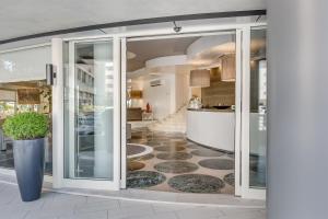 a hallway with sliding glass doors and a floor at Hotel Mariver in Lido di Jesolo