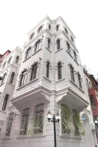 a white building with windows and a street light at Taksim Tulip Residences & Apart Hotel in Istanbul