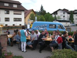 a group of people sitting at tables with food at Hotel Burg Waldau in Grasellenbach