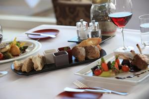 
a table topped with plates of food and wine glasses at Atlantic Grand Hotel Travemünde in Travemünde
