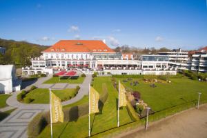 
a large building with a lot of green grass at Atlantic Grand Hotel Travemünde in Travemünde
