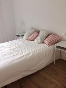 a white bed with two pillows on top of it at Ventana al Pirineo in Jaca