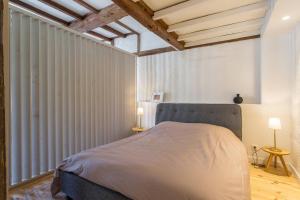 Кровать или кровати в номере Sur les hauteurs du Vieux Lyon
