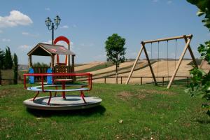 a playground with a slide and a swing set at Don Giovanni Hotel in Sambuca di Sicilia