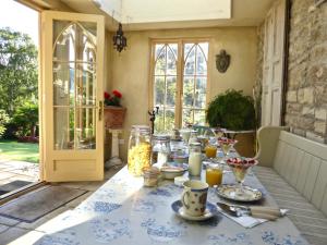 a table with food on it in a room with a door at Dolphin House in Bath