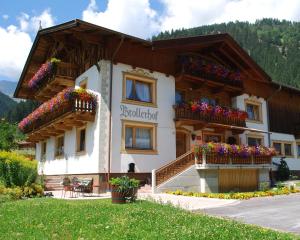 a building with flowers in the balconies on it at Brollerhof in Neustift im Stubaital