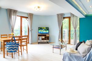 a living room with a couch and a table at ApartHotel Prostor in Kavarna