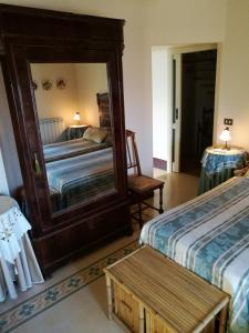 a bedroom with two beds and a mirror at B&B Palazzo Gambino in Acireale